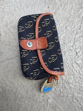 Dooney & Bourke Tan Canvas Interior with Red and Blue Logo Tag